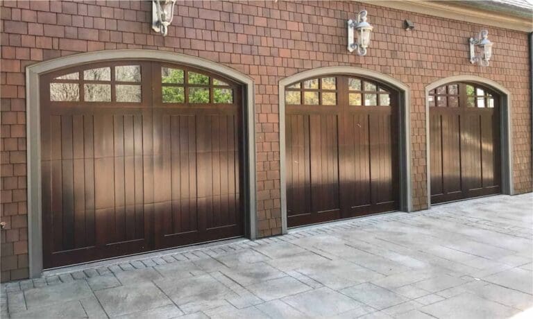 brown three garage doors with glass